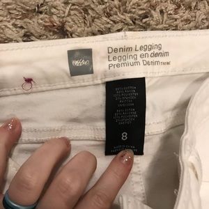 White jeans with zipper on the bottom at the sides